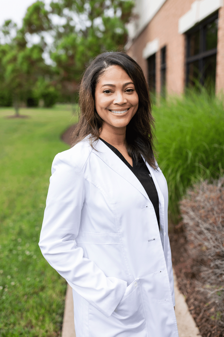 Orthodontist in Chesapeake and Suffolk, VA Dr. Monica Woodard smiling in her white coat