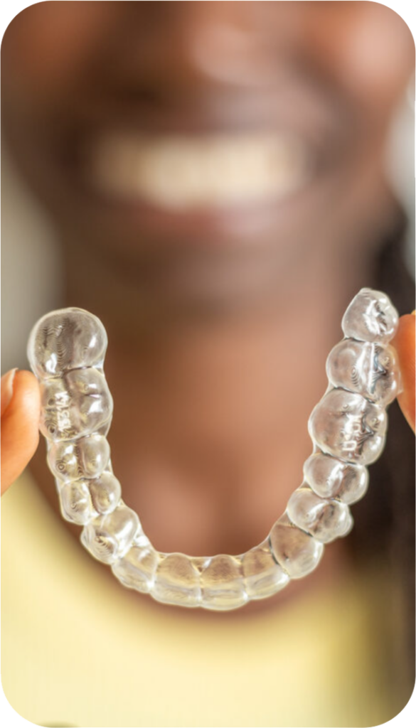 Woman holding her Invisalign® tray out in front of her.